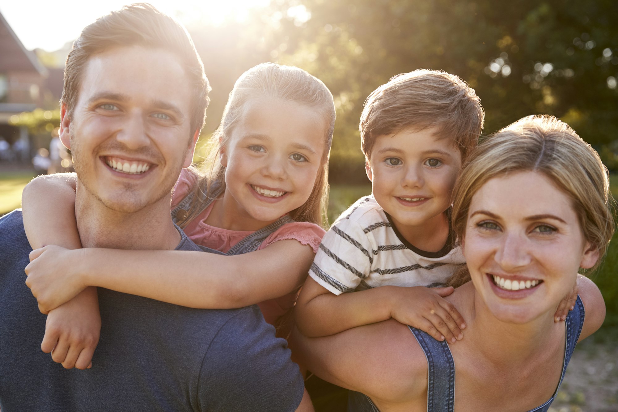 Happy young family smiling at Dalin Dental Associates, showcasing comprehensive dental care for all ages in St. Louis, MO.